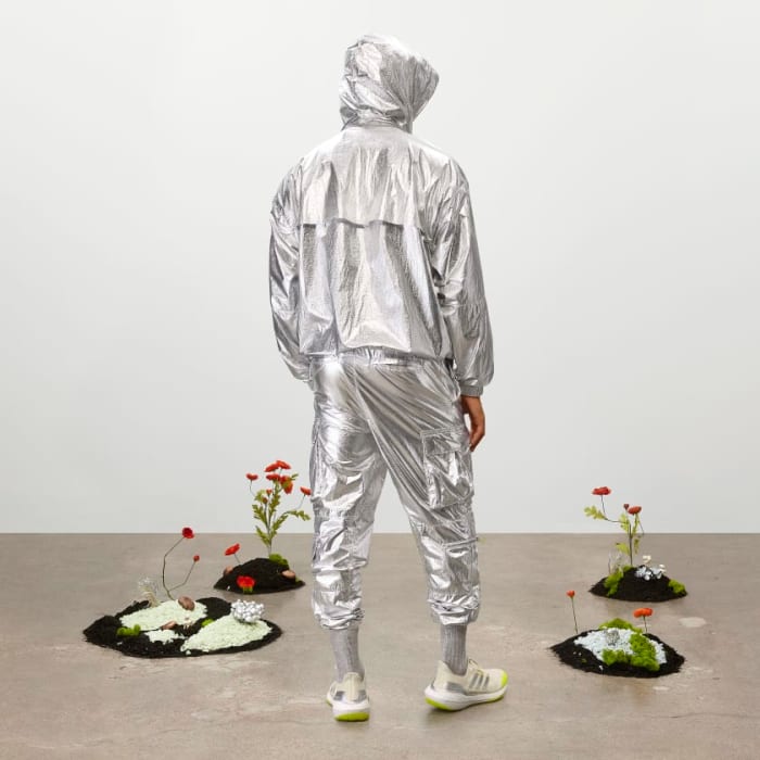 Model wearing metallic tracksuit.